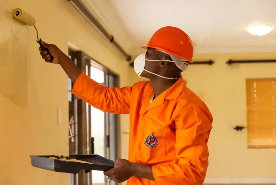 Professional painter applying Legend Paints on a Lagos site